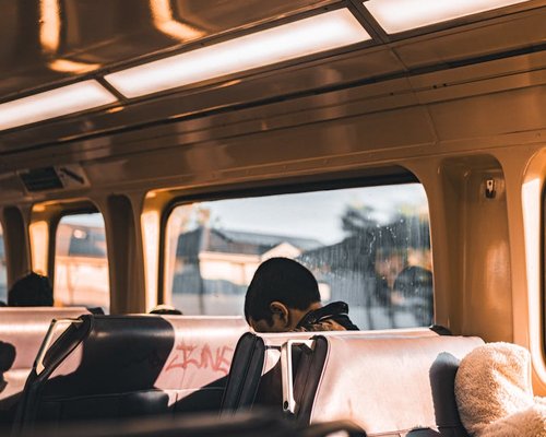 Person commuting on a public bus looking out the window
