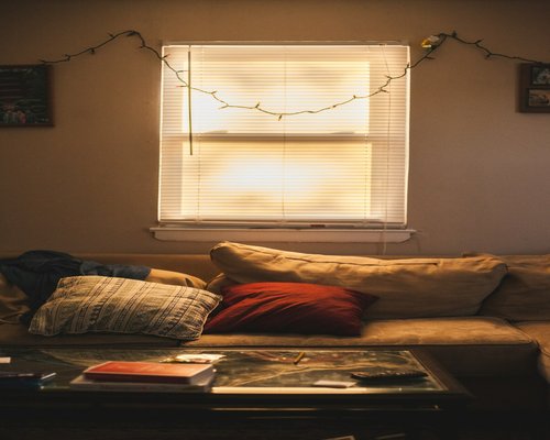 Cozy living room with warm evening light and a sofa